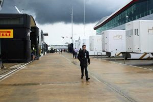 Tom Wilkinson strides around the F1 paddock.